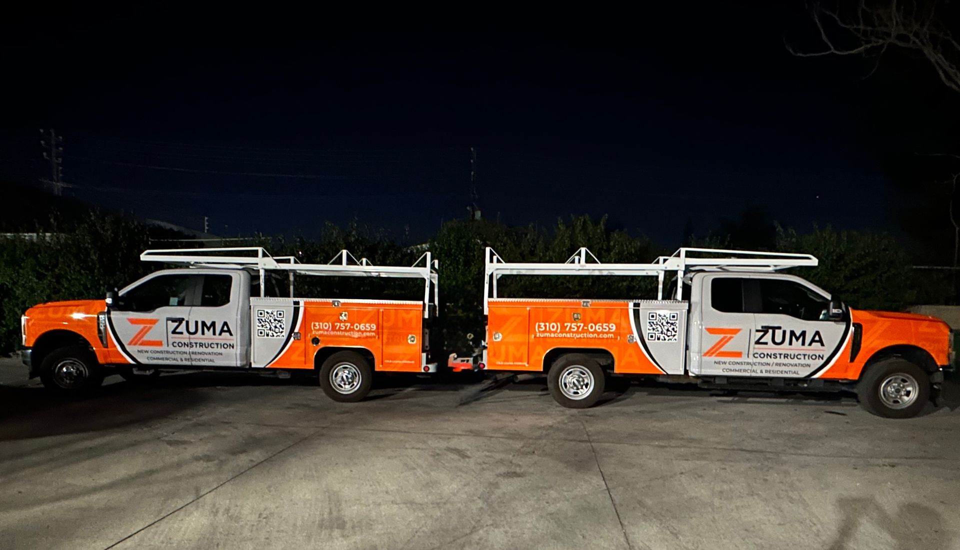Zuma Construction trucks in the company's orange and white livery